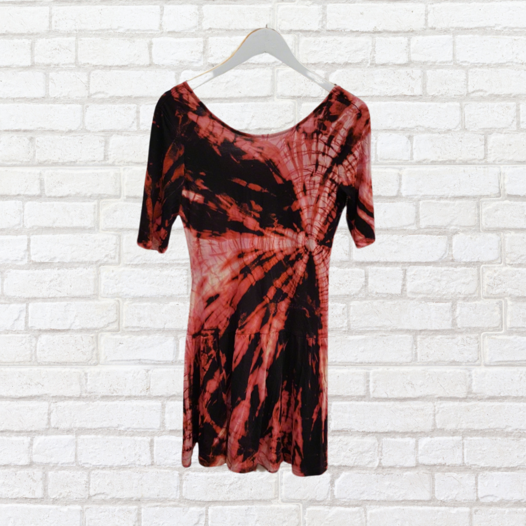 Unleash your inner fashionista with our Shibori style bleach dye mini dress, a stunning blend of upcycled design and bold artistry.
Crafted from soft jersey fabric, this bodycon dress boasts a daring low back and 3/4 sleeves, making it perfect for those who love to make a statement. Available in a unique black and rust shades, this UK size 10 dress is not just a piece of clothing; it’s a fearless expression of your individuality.