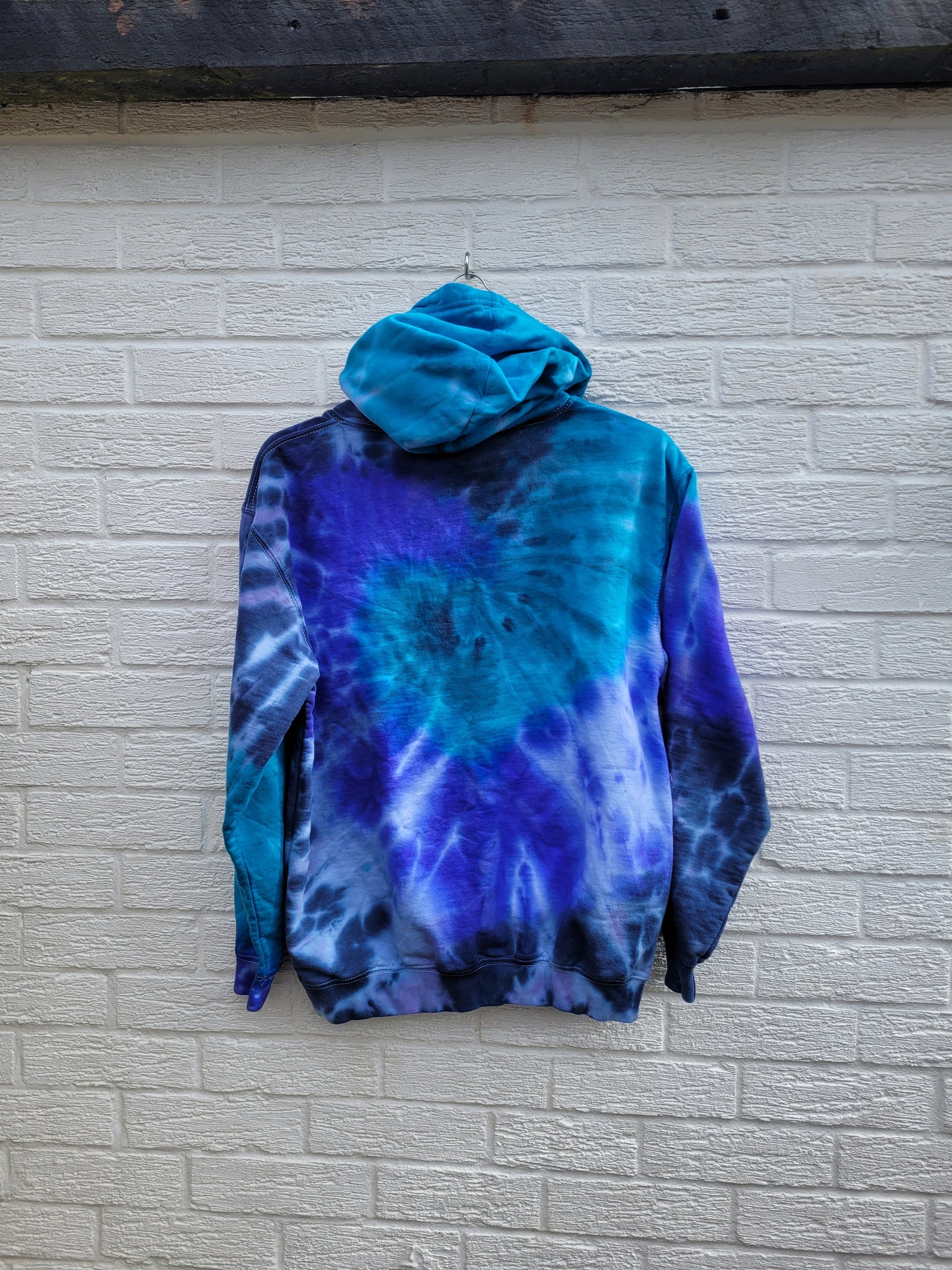Organic cotton tie dye hoodie, in aqua, blue and navy shades, the perfect cosy cover up for the coming summer evenings.

These one of a kind hoodies are hand dyed to order, in 80% Organic Cotton, 20% Recycled Polyester, double fabric hood, front pouch pocket, ribbed cuffs and hem

