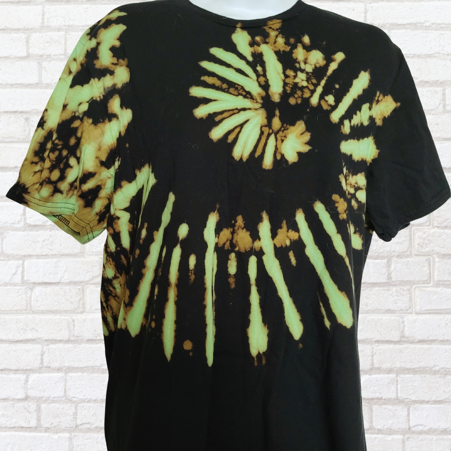 AbiDashery black and green tie-dye t-shirt on a mannequin against a white wall — Heart Chakra Collection
