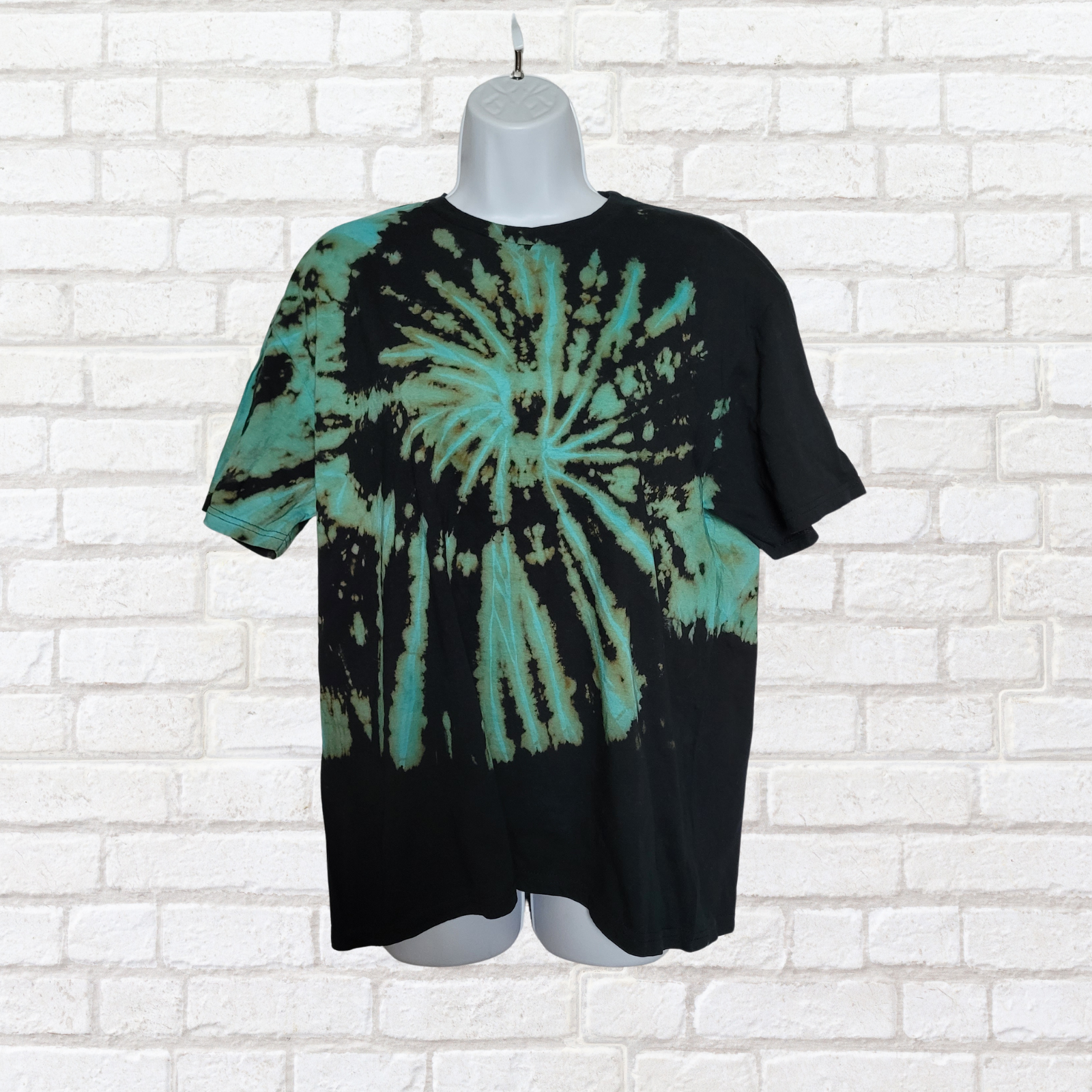 AbiDashery black and blue tie-dye t-shirt on a mannequin against a white wall — Throat Chakra Collection

