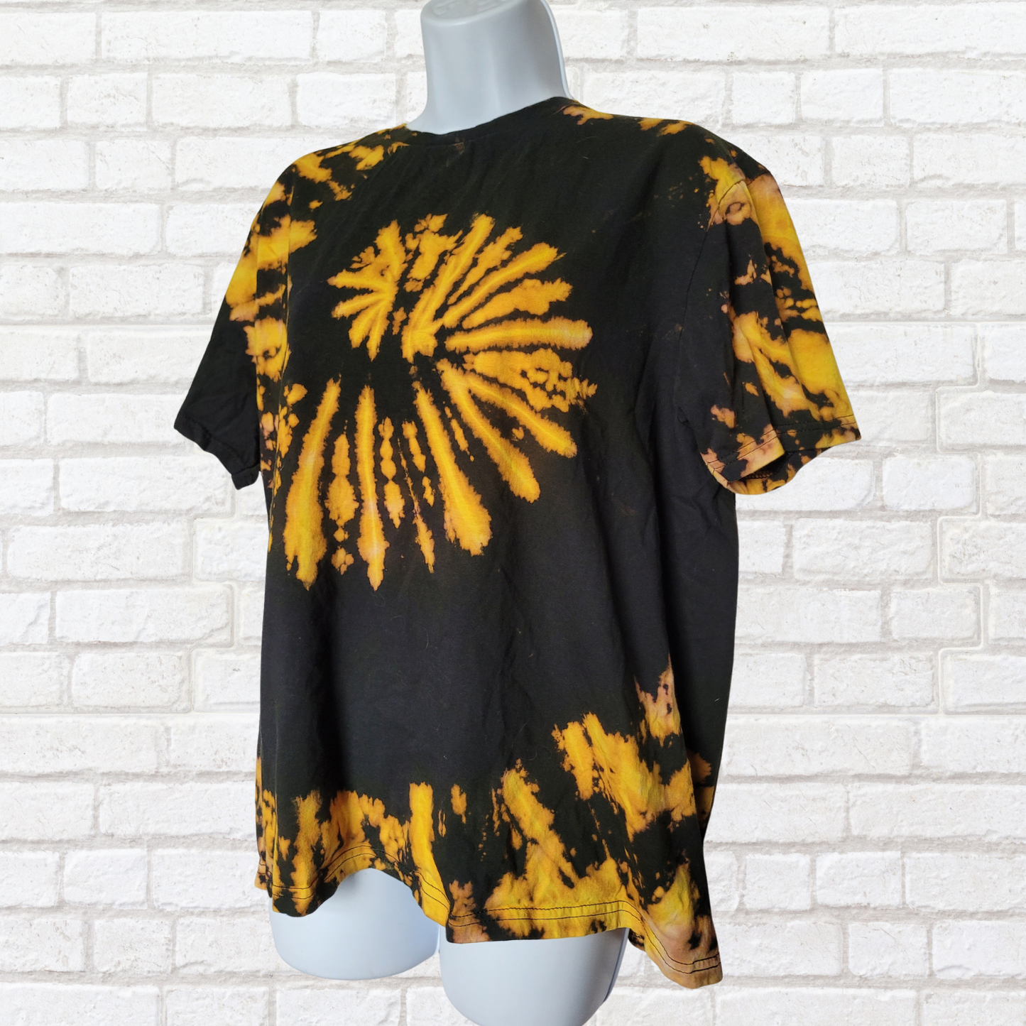AbiDashery black and yellow tie-dye t-shirt on a mannequin against a white wall — Solar Plexus Chakra Collection
