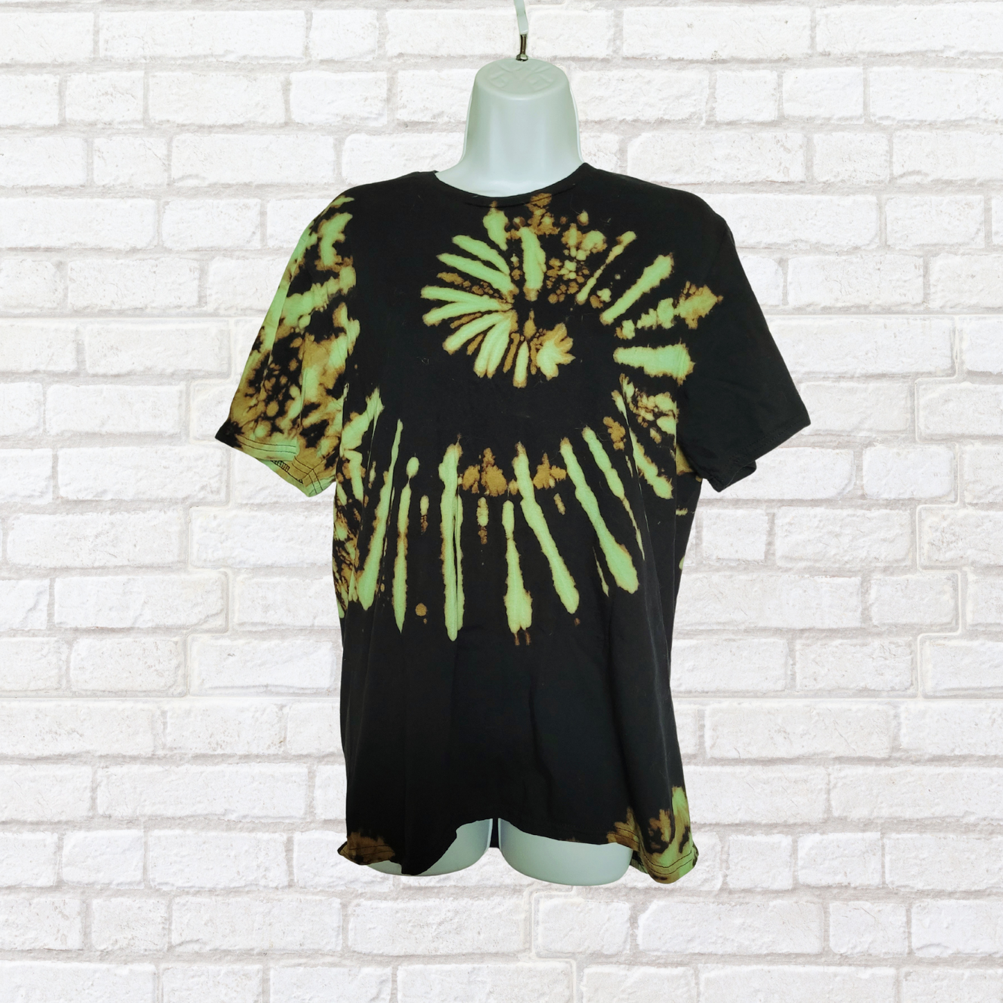 AbiDashery black and green tie-dye t-shirt on a mannequin against a white wall — Heart Chakra Collection
