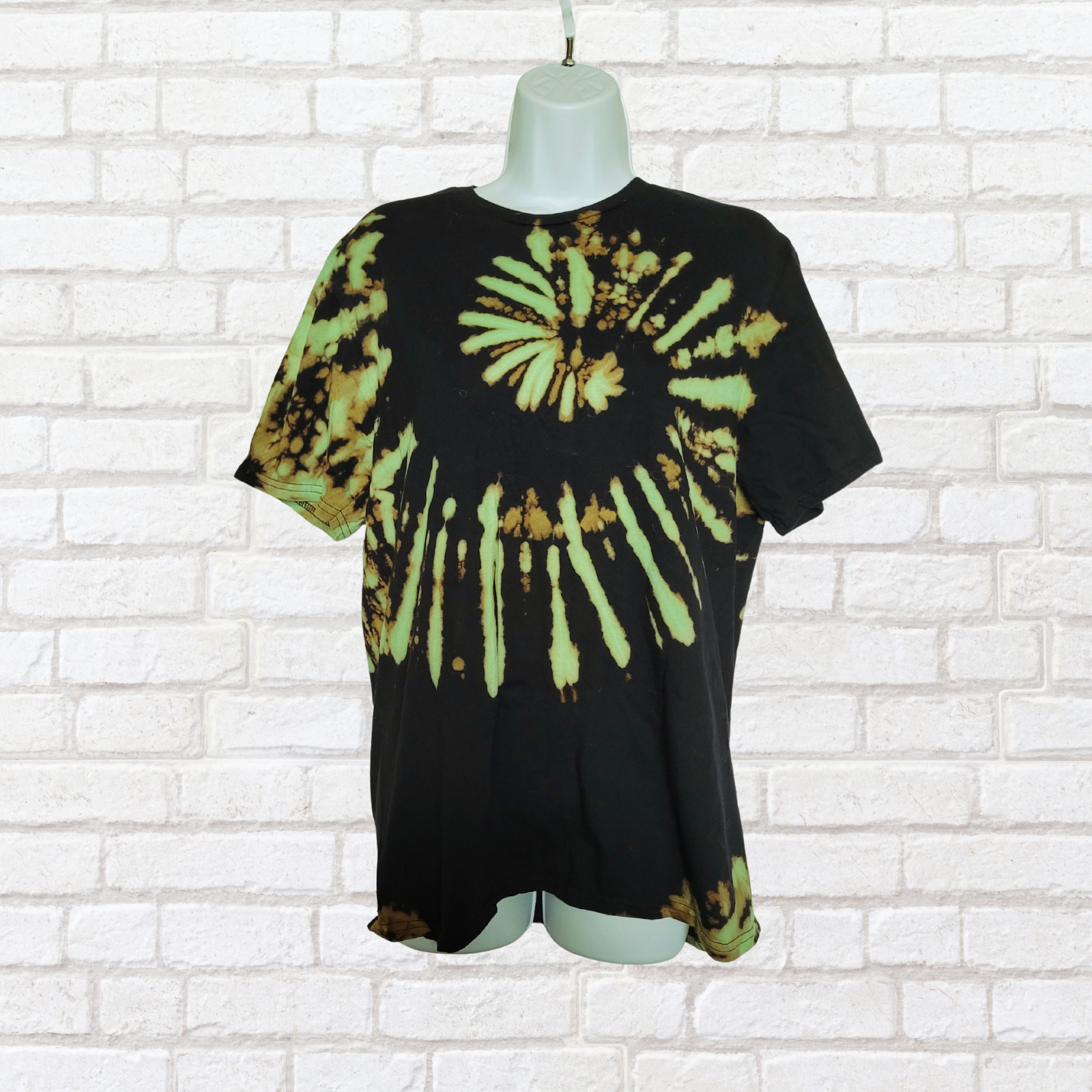 AbiDashery black and green tie-dye t-shirt on a mannequin against a white wall — Heart Chakra Collection
