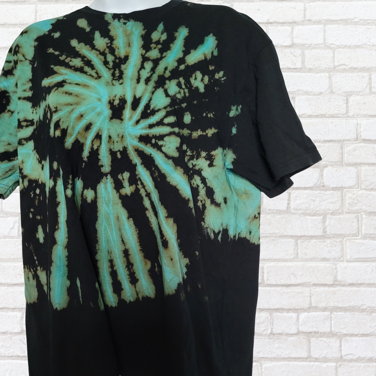 AbiDashery black and blue tie-dye t-shirt on a mannequin against a white wall — Throat Chakra Collection
