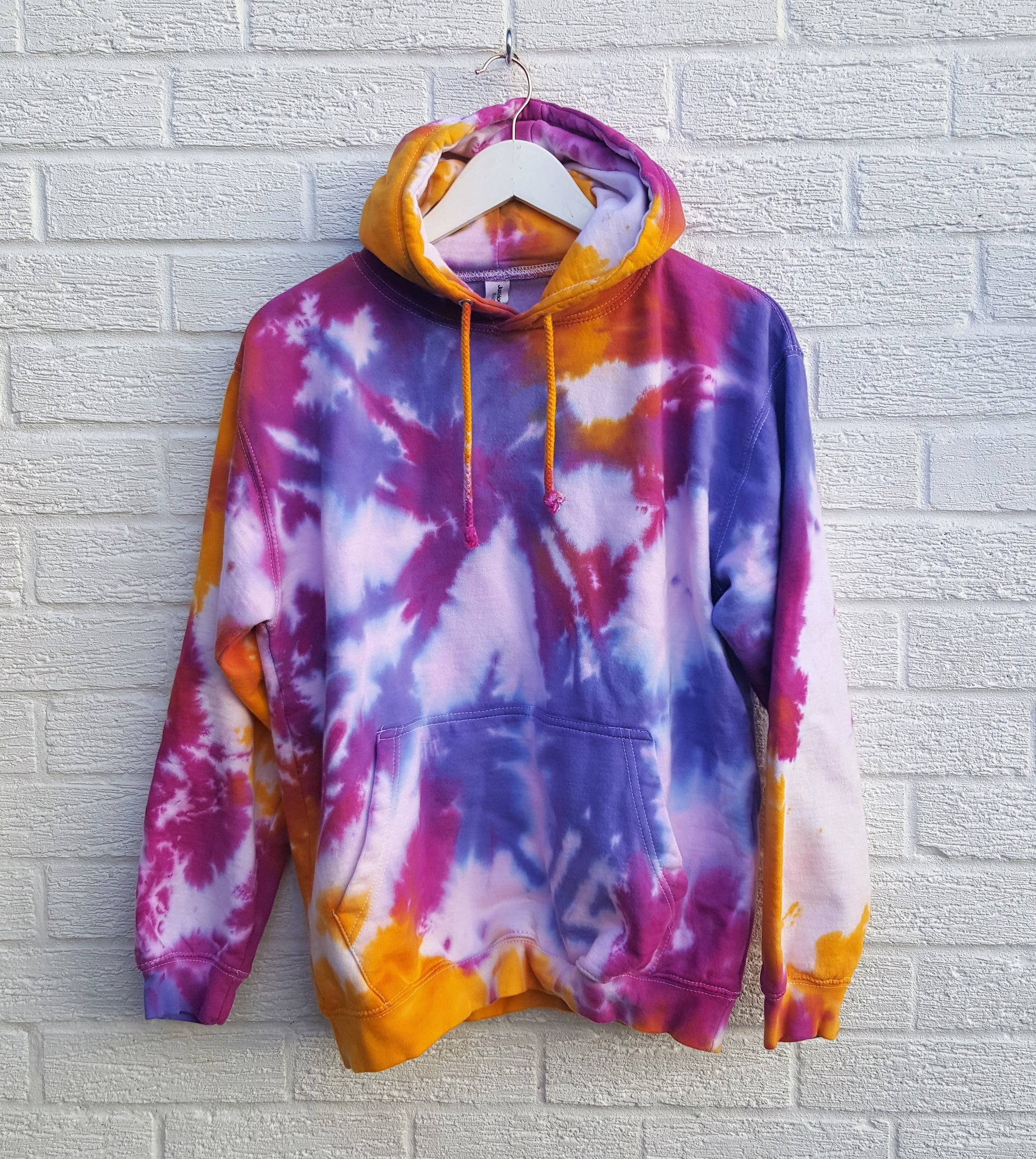 Tie dye hoodie, in orange, pink & purple shades, the perfect colourful cover up for the coming festive season, in men's/unisex sizes.  These one of a kind hoodies are hand dyed to order, in 80% Organic Cotton, 20% Recycled Polyester, double fabric hood, front pouch pocket, ribbed cuffs and hem.  Hand dyed in the UK by AbiDashery.