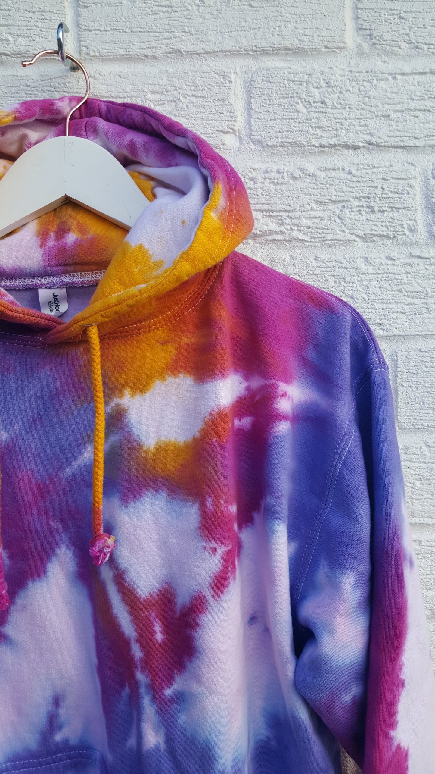 Tie dye hoodie, in orange, pink & purple shades, the perfect colourful cover up for the coming festive season, in men's/unisex sizes.  These one of a kind hoodies are hand dyed to order, in 80% Organic Cotton, 20% Recycled Polyester, double fabric hood, front pouch pocket, ribbed cuffs and hem.  Hand dyed in the UK by AbiDashery.