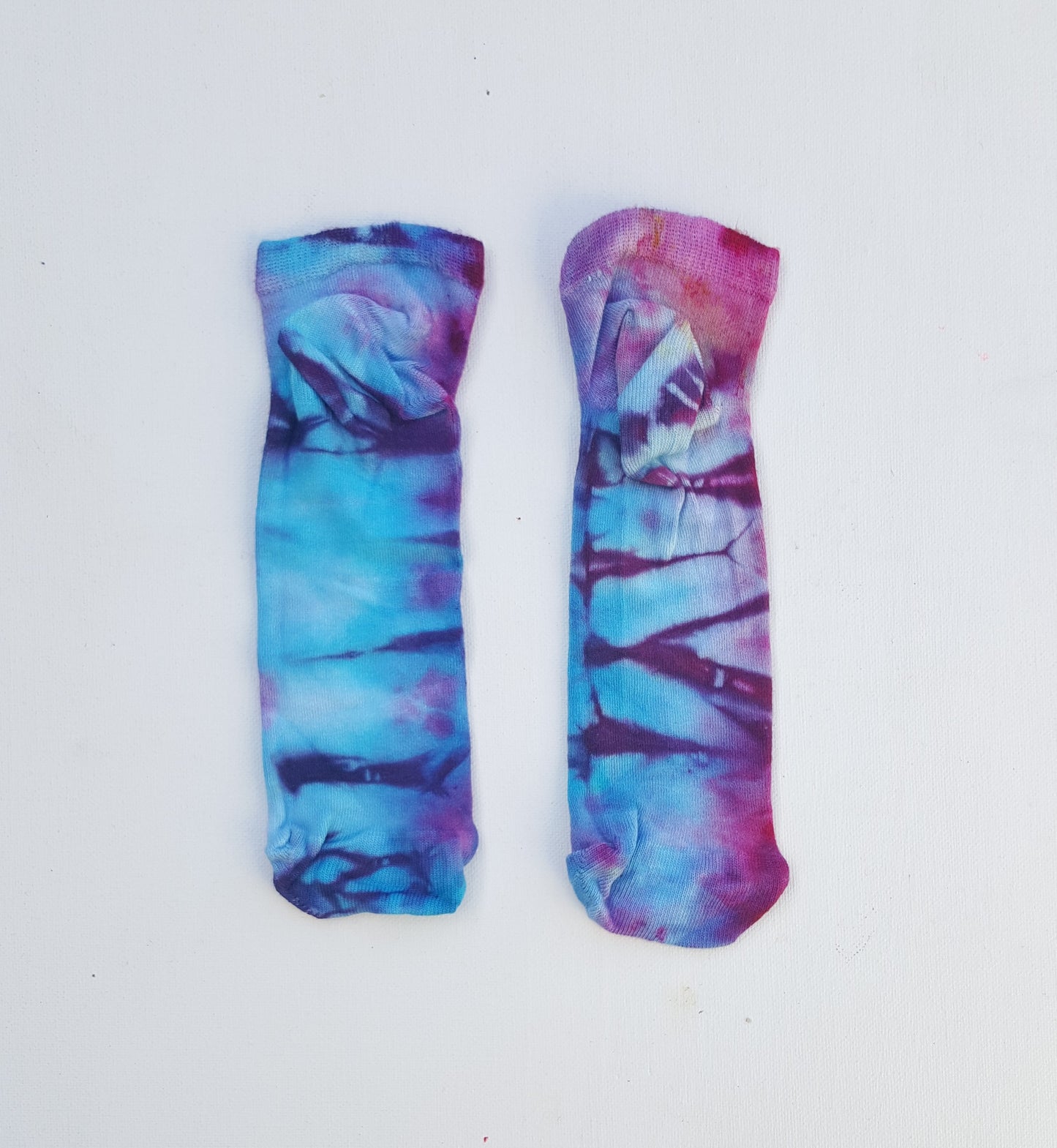 One pair of hand dyed bamboo trainer socks, in ice tie dye colours. Each is pair is unique and hand dyed with love, there's a huge variety of colours available and a pair will be chosen at random for you, each pair is unique and hand dyed!  Made with natural organic bamboo fibres, light and breathable. 80% bamboo, 17% polyamide, 3% elastane .  To fit women's size UK 4-8 - EUR 37-42 - US 6-10