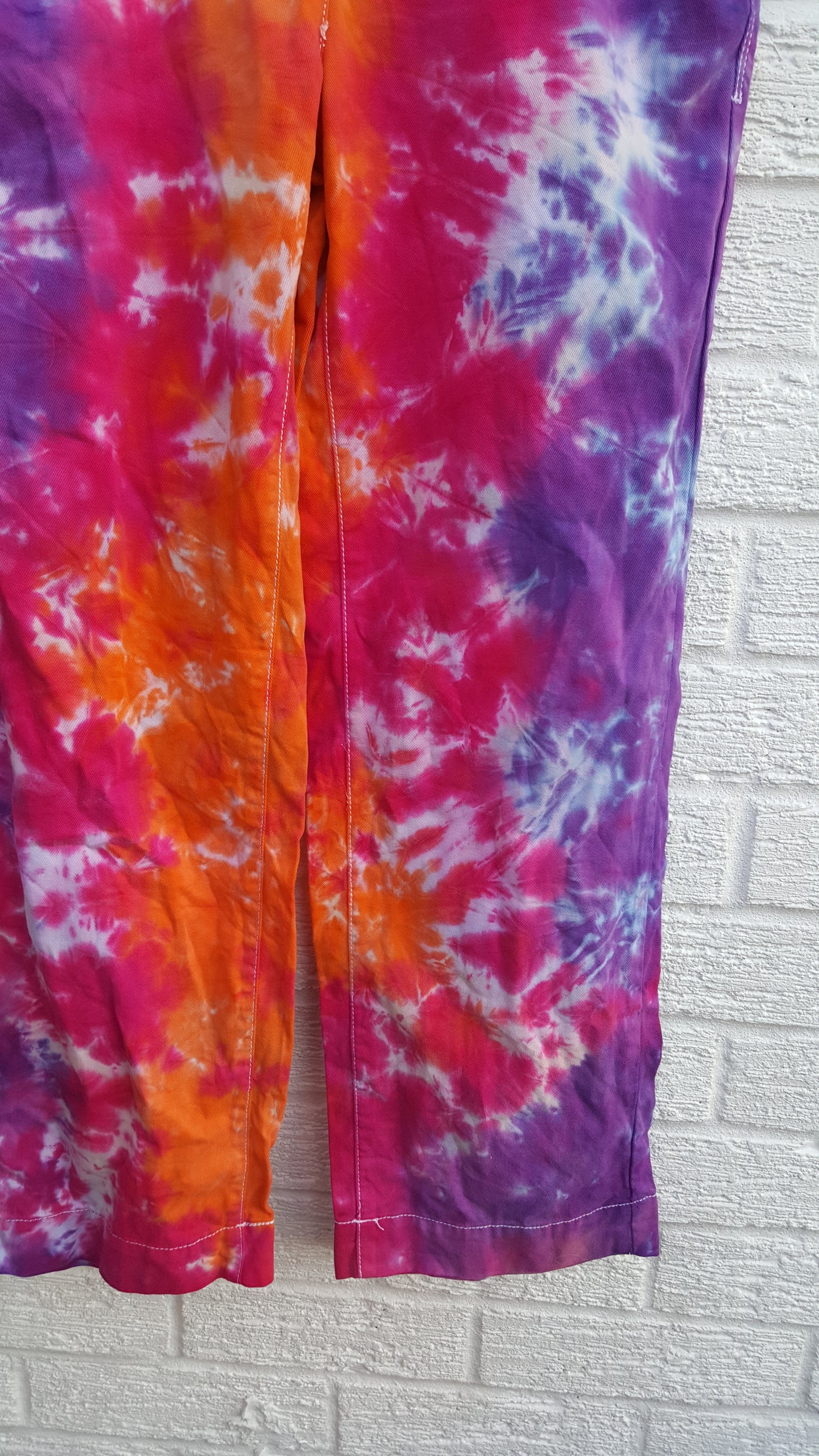 Tie dye trousers, in bright orange, pink and purple shades - perfect for the hippie at heart! In 100% Cotton to fit UK size 6R or US size 2.  These trousers were thrifted and upcycled using cold water, eco reactive dyes, so they're not just unique, they're friendlier to the environment too.  Hand dyed with love by AbiDashery.  We only use recycled and compostable packaging!
