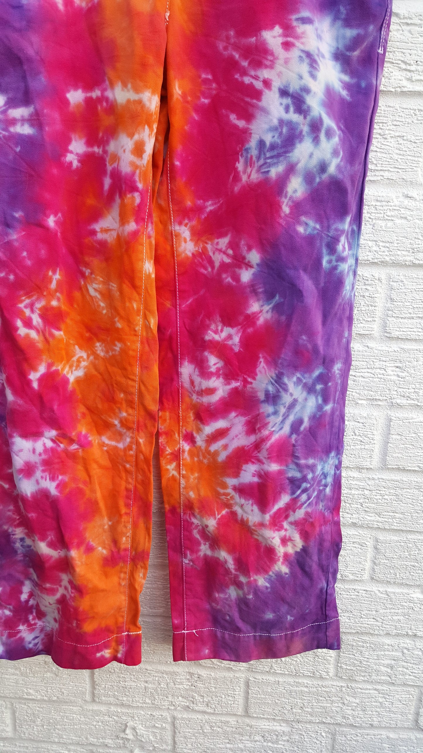 Tie dye trousers, in bright orange, pink and purple shades - perfect for the hippie at heart! In 100% Cotton to fit UK size 6R or US size 2.  These trousers were thrifted and upcycled using cold water, eco reactive dyes, so they're not just unique, they're friendlier to the environment too.  Hand dyed with love by AbiDashery.  We only use recycled and compostable packaging!