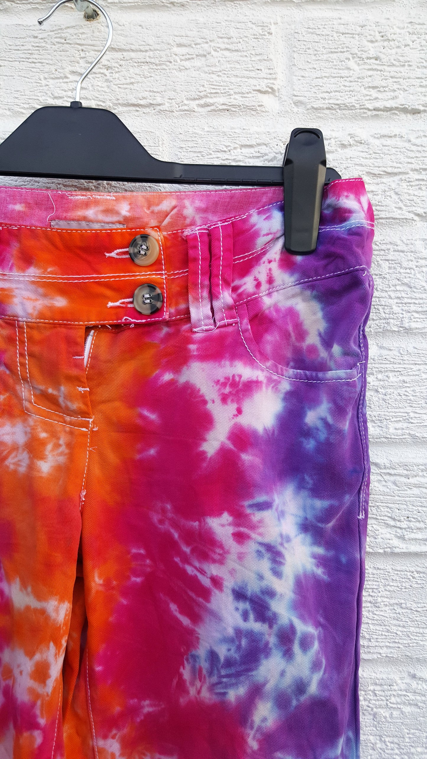 Tie dye trousers, in bright orange, pink and purple shades - perfect for the hippie at heart! In 100% Cotton to fit UK size 6R or US size 2.  These trousers were thrifted and upcycled using cold water, eco reactive dyes, so they're not just unique, they're friendlier to the environment too.  Hand dyed with love by AbiDashery.  We only use recycled and compostable packaging!